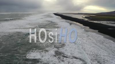 Aerial Of Waves Lapping The Shoreline Of Reynisfjara Black Sand Beach On The South Coast Of Iceland - Video Drone Footage