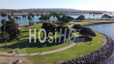 Aerial Of People Riding Bicycles At Mission Point Park, San Diego, California - Video Drone Footage