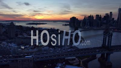 Aerial Panning Shot Of Manhattan And Brooklyn Bridge With New York City Manhattan Skyline Distant, Dusk - Video Drone Footage