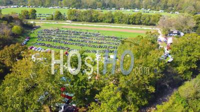 Good Aerial Over Bikers Arriving At A Huge Biker Rally In Ohio And Parking Motorcycles In Large Field - Video Drone Footage