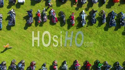 Good Top Down Aerial Over Bikers Arriving At A Huge Biker Rally In Ohio And Parking Motorcycles In Large Field - Video Drone Footage
