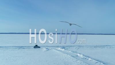 Car Driving On Huge Frozen Lake, Mille Lacs, Minnesota, Usa - Video Drone Footage