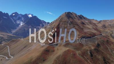 The Road Between Col Du Lautaret And Col Du Galibier In Autumn Color, Hautes-Alpes, France, Viewed From Drone