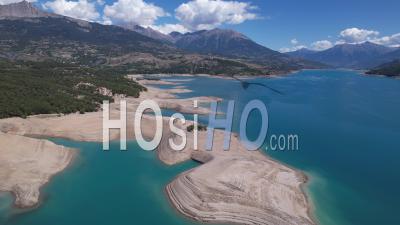The Serre Ponçon Lake In Summer With A Very Low Level Due To Drought, Hautes-Alpes, France, Viewed From Drone