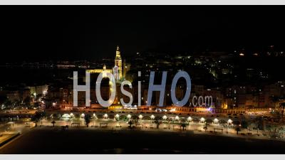 Menton By Night, The Old Town Dominated By The Basilica Of Saint Michel, Alpes-Maritimes, France - Video Drone Footage