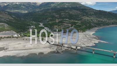 The Serre-Poncon Lake And The Savines-Le-Lac Bridge, Hautes-Alpes, France - Video Drone Footage