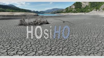 Heatwave, Dry Earth Cracked In A Period Of Drought On The Ubaye River At The Entrance Of The Serre-Poncon Lake During The 2022 Drought, Hautes-Alpes, France - Video Drone Footage