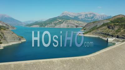 Serre-Poncon Dam On The Durance And Its Lake Surrounded By Mountains, France, Drone Point Of View