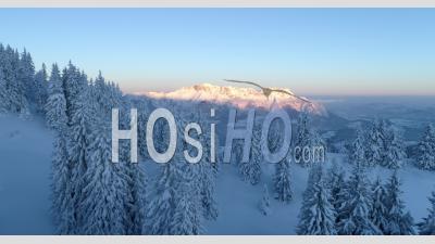 Aerial Footage Of Snow Covered Mountain Landscape At Sunrise - Video Drone Footage