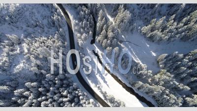 Aerial Footage Of Cars On Road Through Snow Covered Landscape - Video Drone Footage
