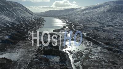 Loch Garry During Winter With Snow-Capped Mountains In The Background - Video Drone Footage