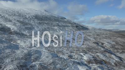 Snow-Capped Mountains Under Winter Sun In The Scottish Highlands - Video Drone Footage