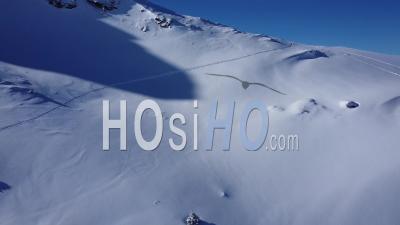 Aerial Shot Of A Ski Track In A Virgin Snowy Mountain - Video Drone Footage