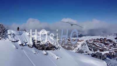 Aerial Shot Of Skiers In Front Of A Ski Resort - Video Drone Footage