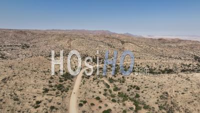 Four-Wheel Drive 4wd Car Driving On Desert Road D1275 Near Spreetshoogte Pass, Namibia - Video Drone Footage