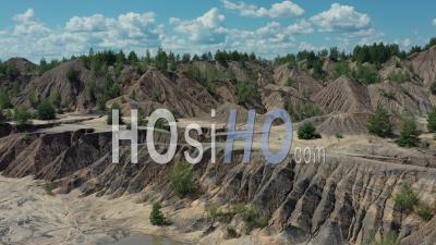 Flying Above The Abandoned Clay Quarry With Canyons And Cracks. - Video Drone Footage