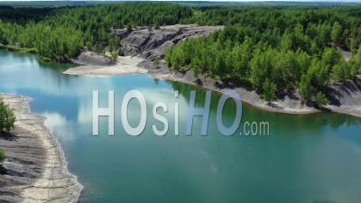 Aerial View Of An Abandoned Quarry, Forest And The Lake With Turquoise Water. - Video Drone Footage