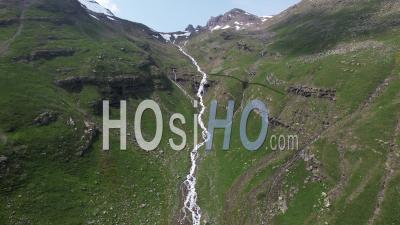 Waterfall Near The Aiguilles D'arve Valley, Viewed From Drone