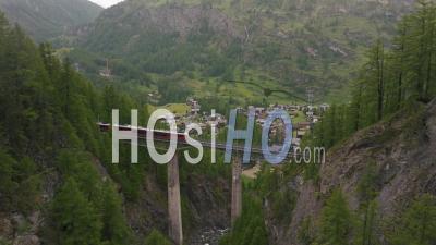Train Crossing A Bridge In Switzerland, Daytime - Video Drone Footage