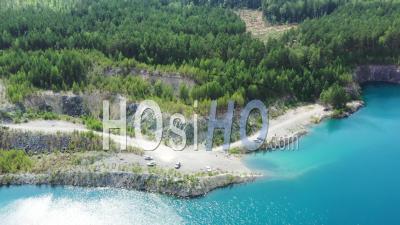Lake With Azure Water In The Forest. Flooded Quarry - Video Drone Footage