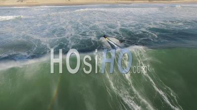Woman Surfer Riding A Wave Followed And Rescued By A Jet Ski, Atlantic Ocean, Video Drone Footage
