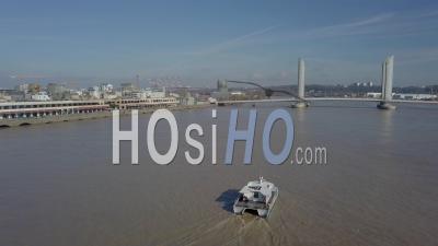 Aerial View Of Bordeaux Public Transport Boat On The Garonne, Chaban Delmas Bridge, France - Video Drone Footage